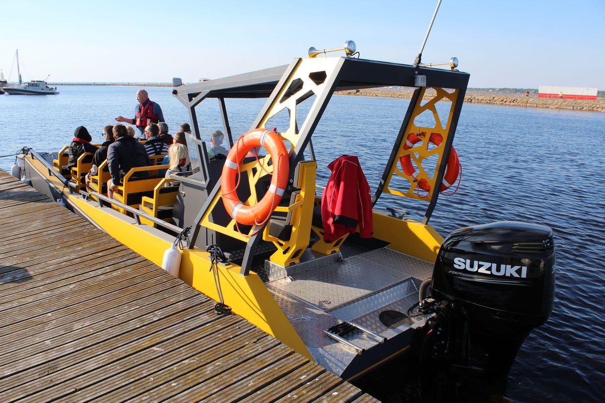 LR9 Safari lying alongside a timber pier with passengers already aboard and the side boarding gate open