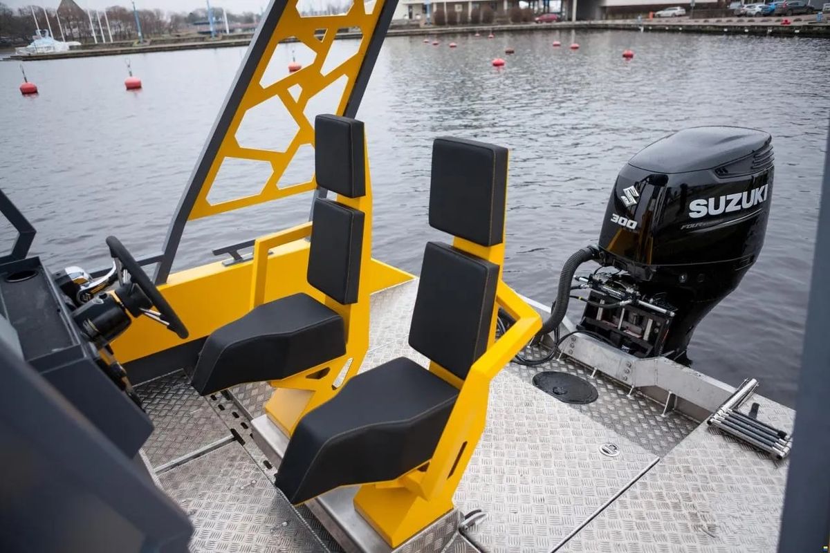 The two crew seats at the aft helm of the LR9 Safari, with a Suzuki 300 outboard on the transom behind them