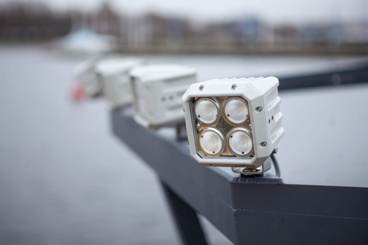 A row of four white LED floodlights bolted along the hardtop rail of the LR9 Safari passenger boat, the nearest one sharp and the others falling away behind it